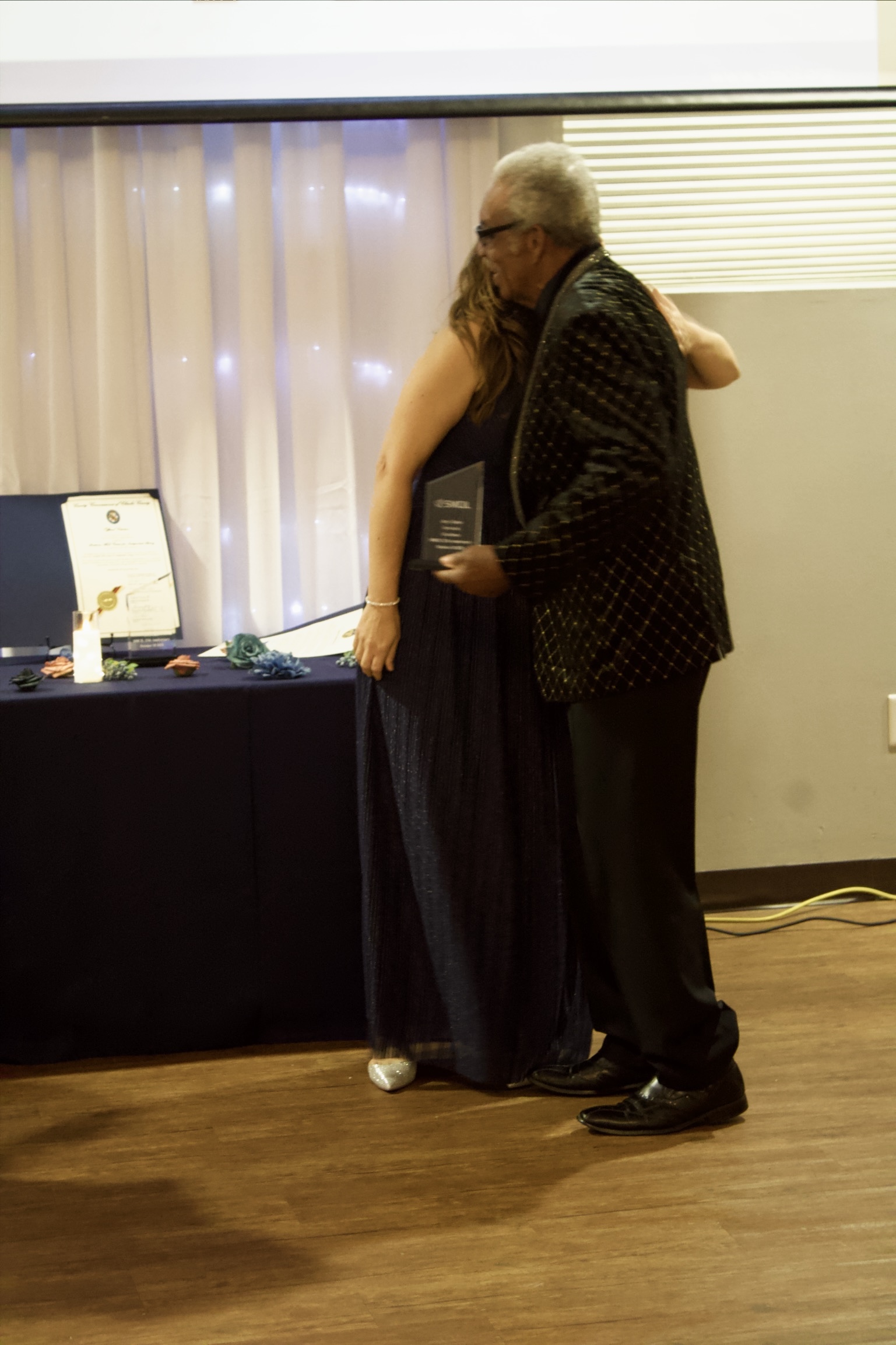 Gala Slideshow - Lidiya embracing Howard Dent with Jerry's award
